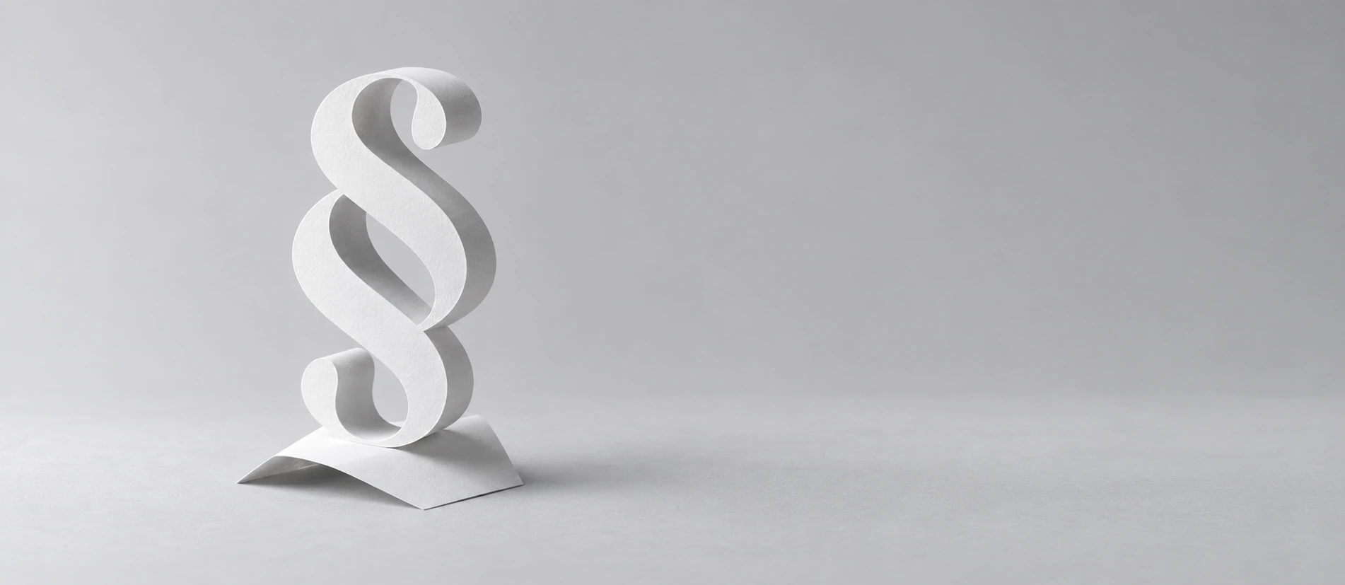 Minimal paper section symbol on a pale grey surface